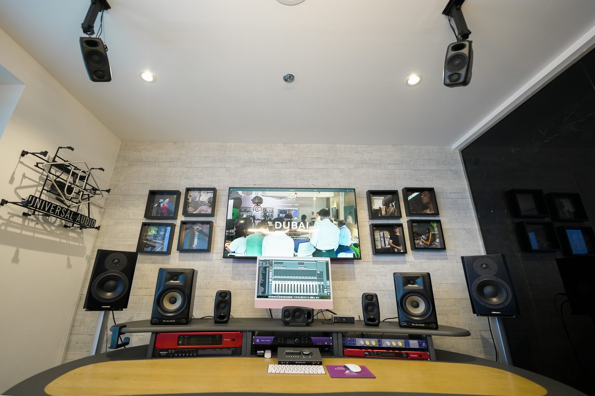 The music creation wall at MCX, monitors and interfaces along the bench