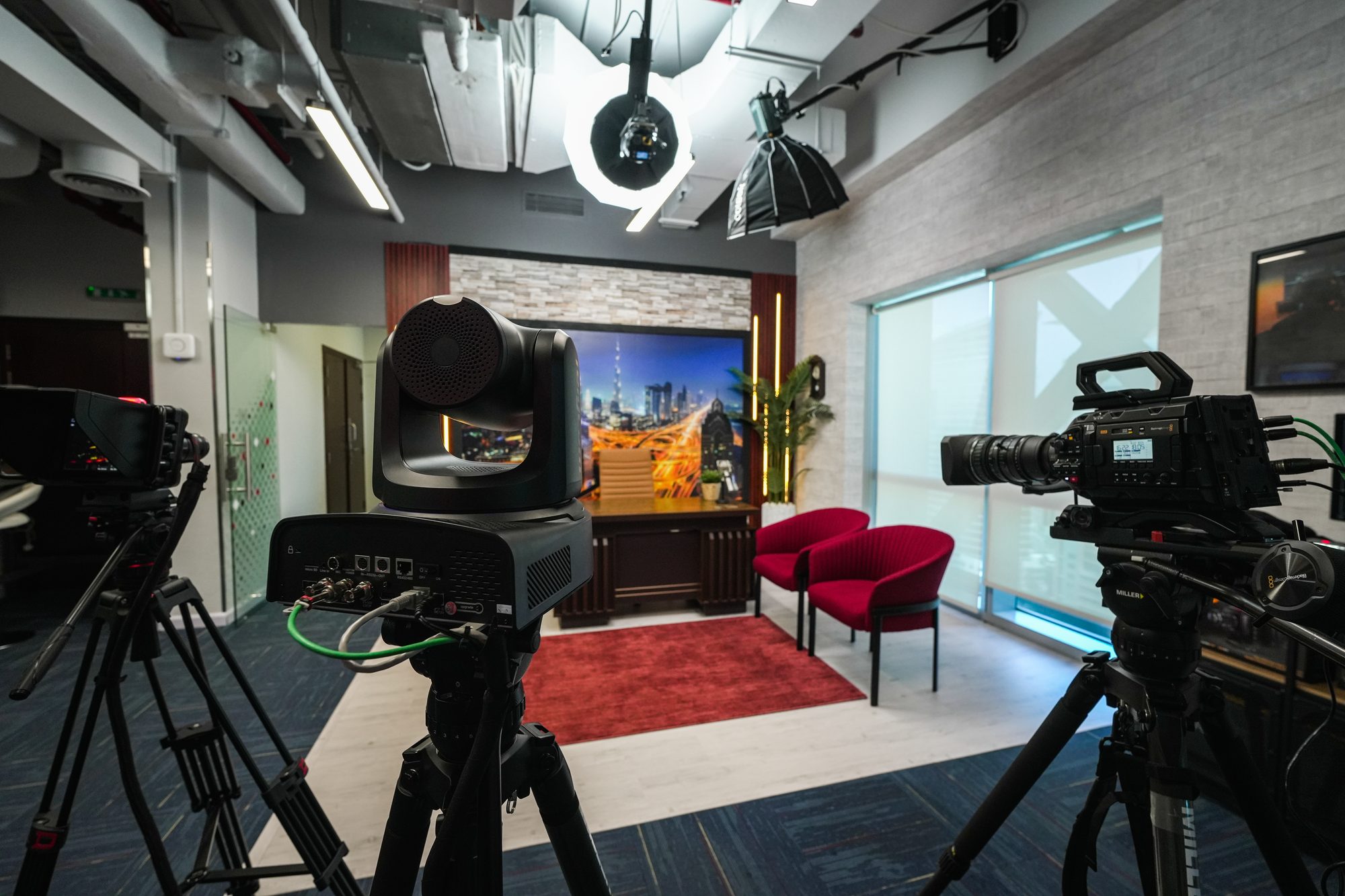 The MCX floor seen wide, studio cameras rigged on tripods facing the presenter set