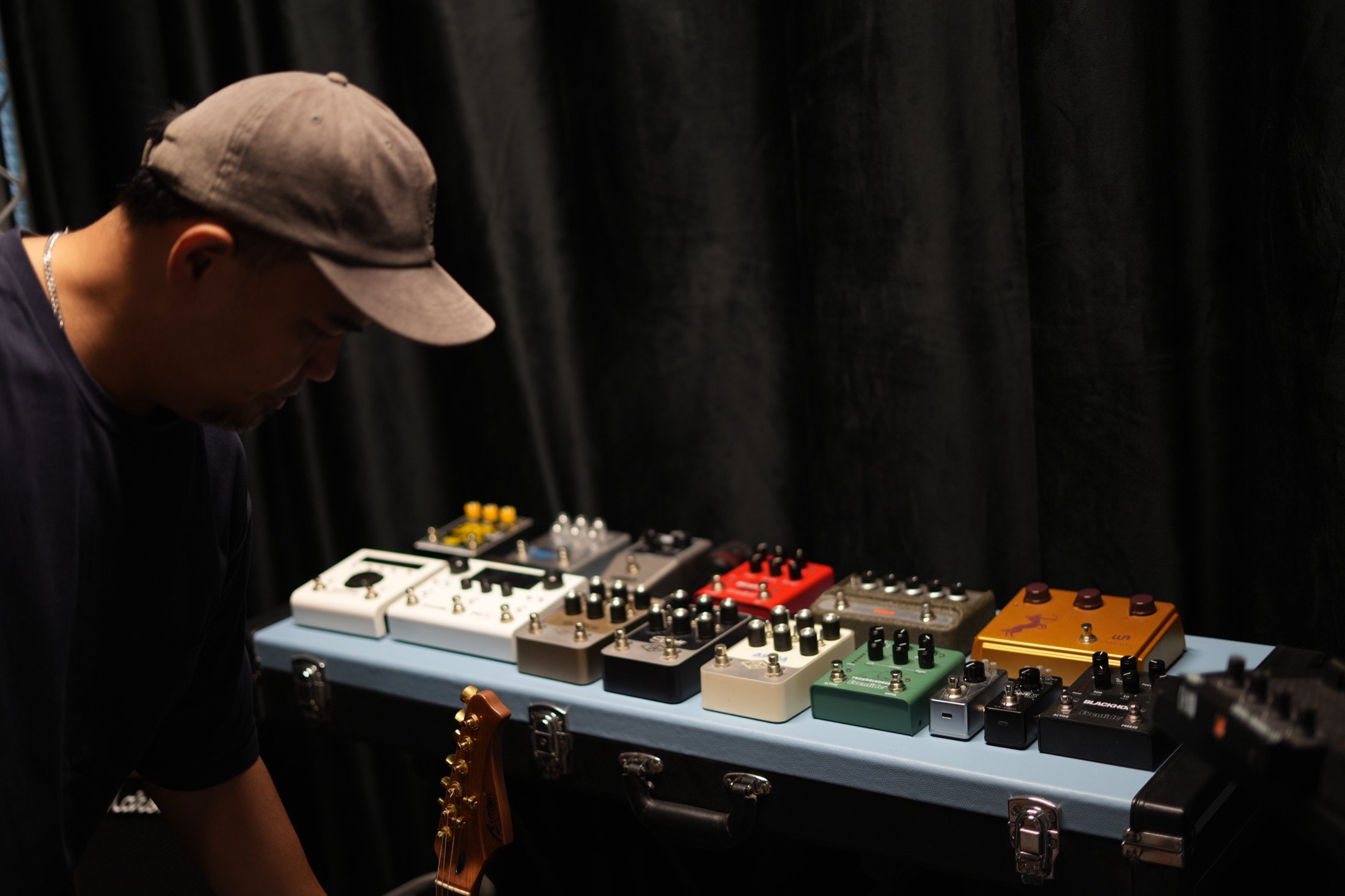 A specialist setting up a pedalboard on the MCX stage
